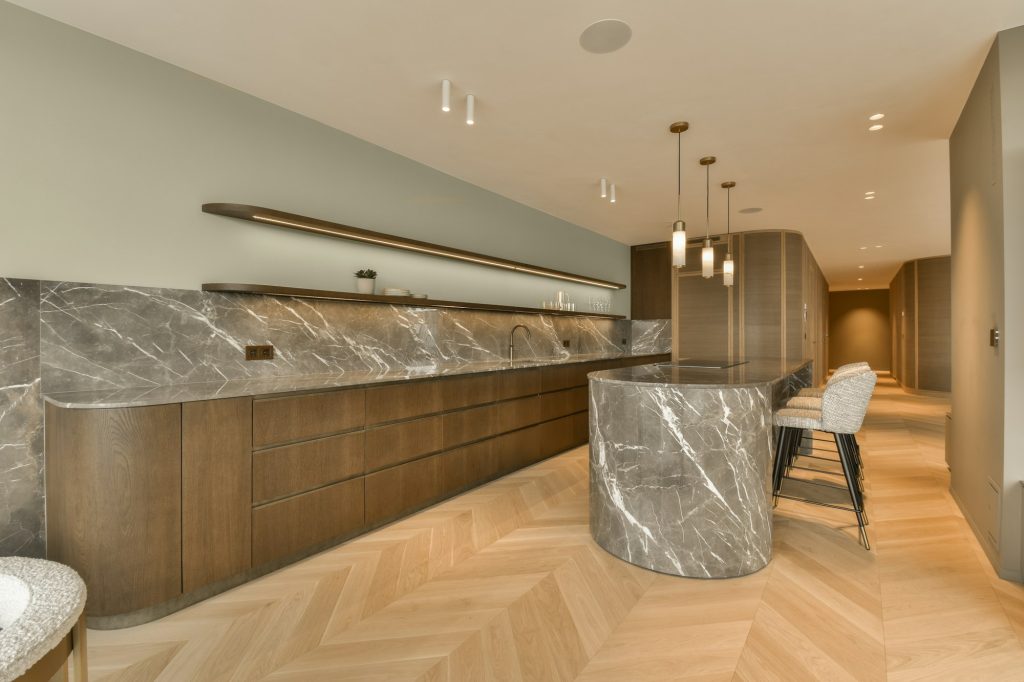 a large kitchen with marble countertops and a bar